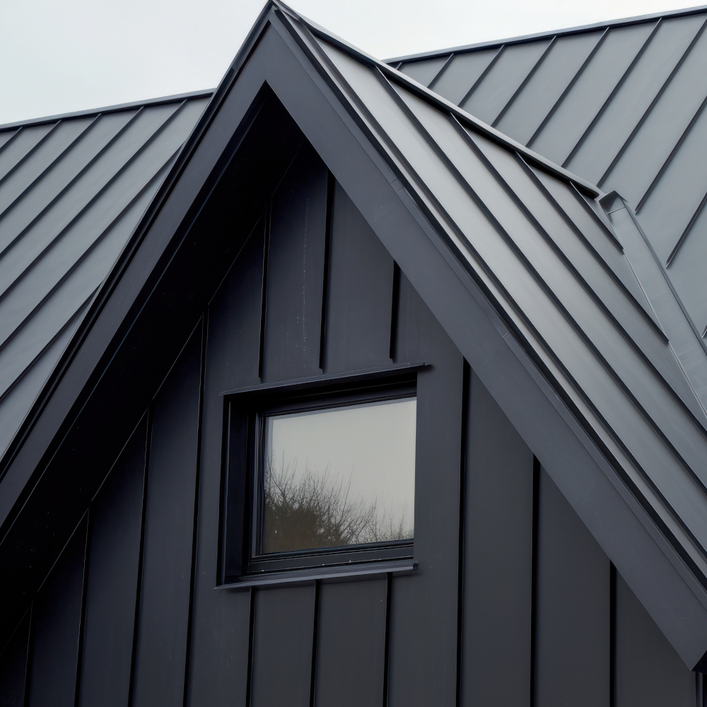 Close up view of modern gray metal roof with sharp angles and sleek design